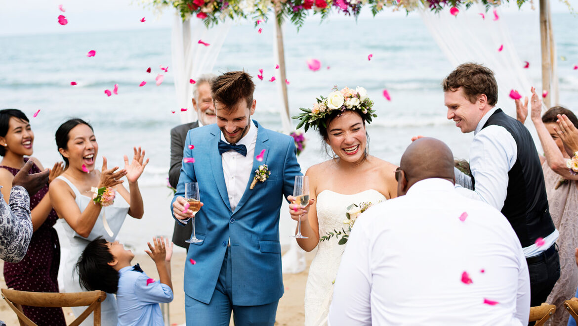 married couple walking down isle of their destination wedding ceremony