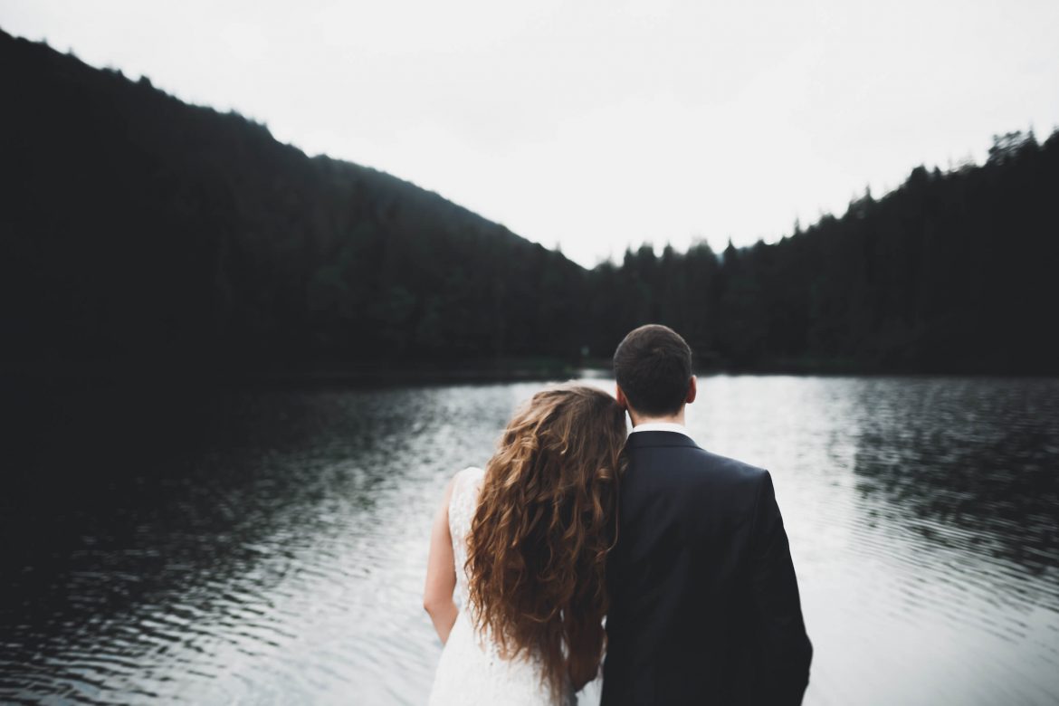 couple on wedding day by lake