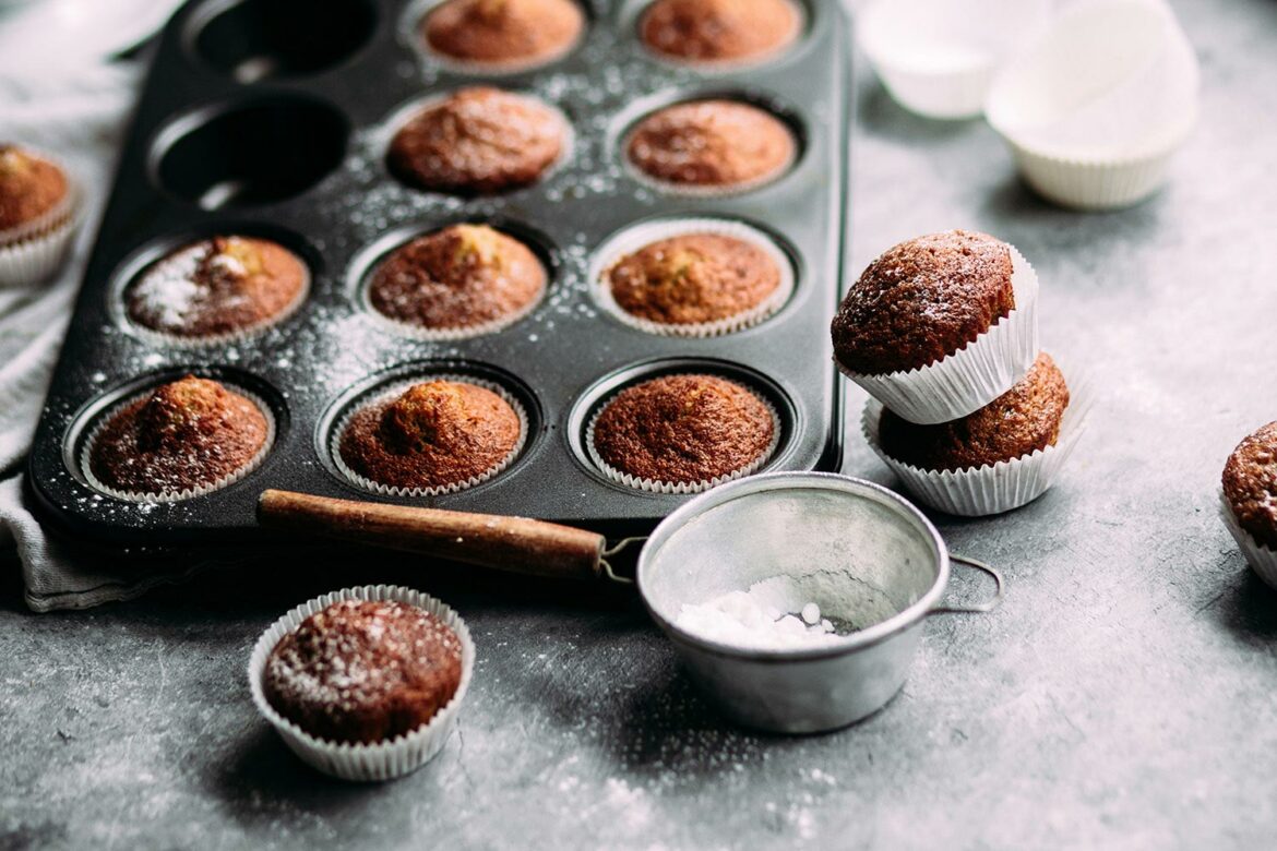 Muffins in a tin and measuring cup on the table