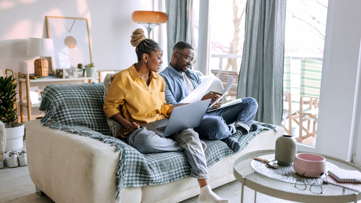 Engaged couple works on their wedding budget template